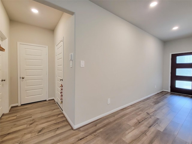 entryway with baseboards, recessed lighting, and light wood-style floors