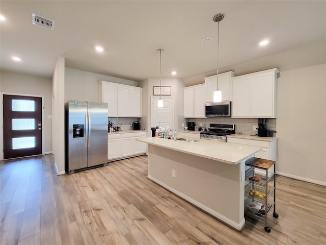 kitchen with light wood-type flooring, white cabinetry, and stainless steel appliances