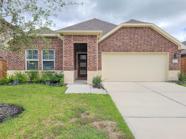 ranch-style home with brick siding, a shingled roof, concrete driveway, a garage, and a front lawn