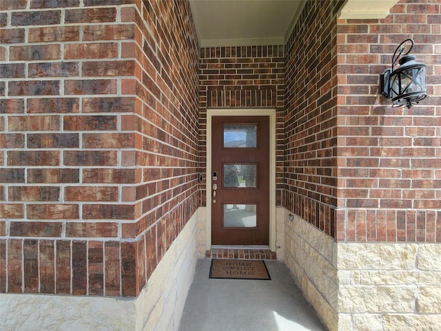 entrance to property with brick siding