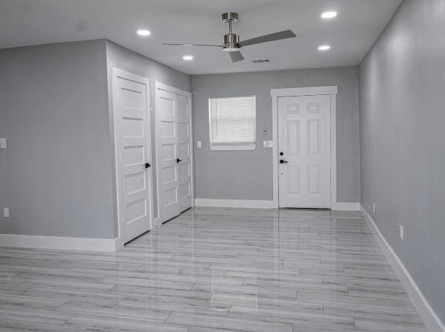 foyer entrance with recessed lighting, a ceiling fan, and baseboards