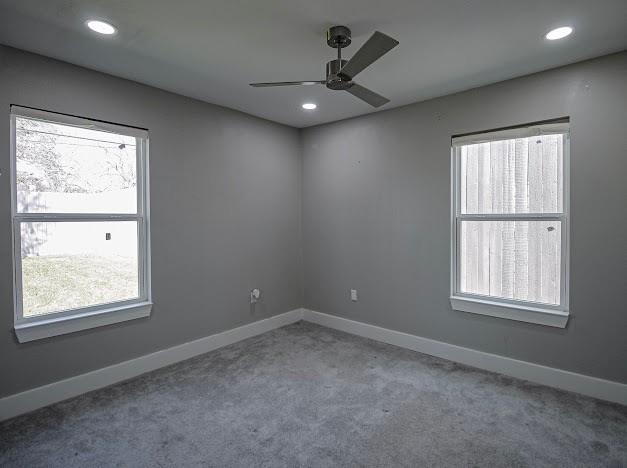 carpeted empty room featuring ceiling fan, baseboards, and recessed lighting