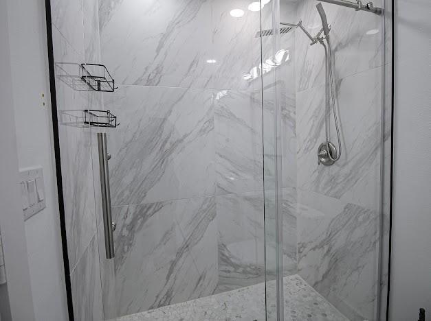 bathroom with a marble finish shower