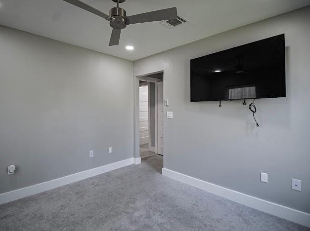 interior space with ceiling fan, carpet floors, visible vents, and baseboards