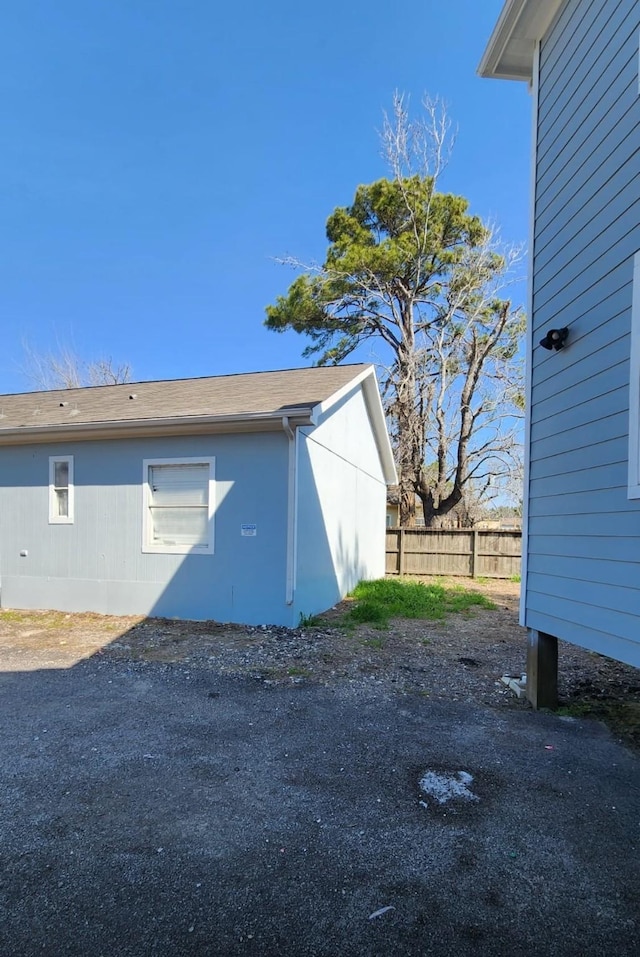 view of home's exterior with fence