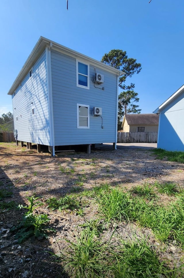 rear view of property featuring fence