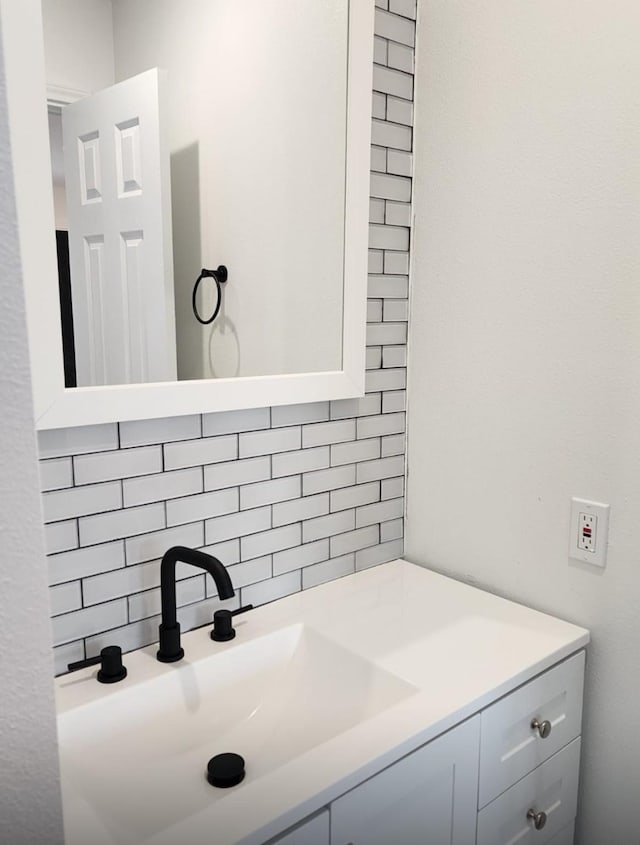 bathroom featuring tasteful backsplash and vanity