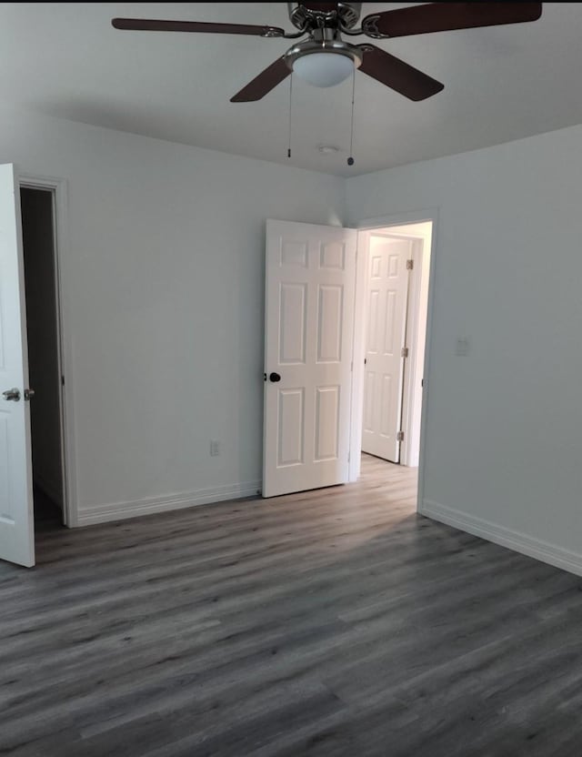 unfurnished room with a ceiling fan, baseboards, and wood finished floors