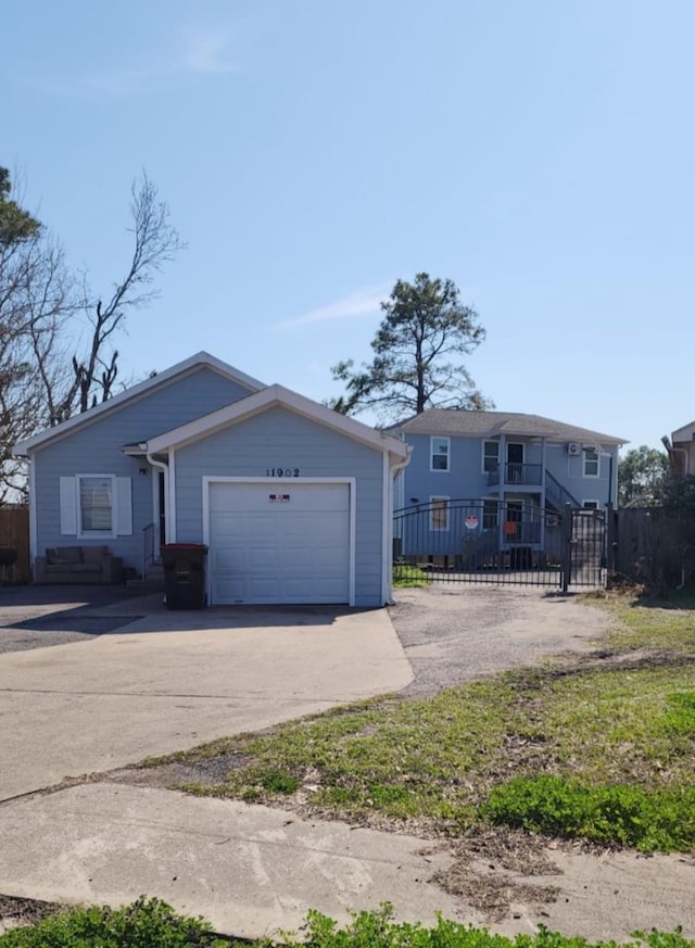 view of front of property with a garage, a fenced front yard, and concrete driveway