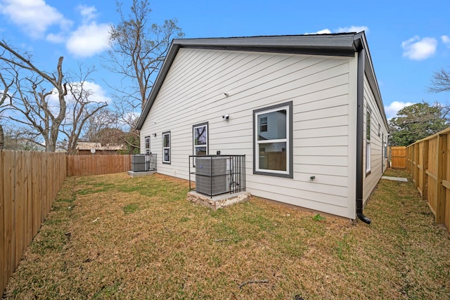 back of property featuring a yard and a fenced backyard