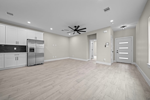 kitchen featuring backsplash, visible vents, ceiling fan, and stainless steel refrigerator with ice dispenser