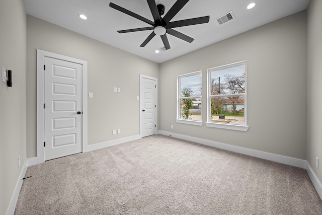 empty room featuring carpet, visible vents, baseboards, and recessed lighting