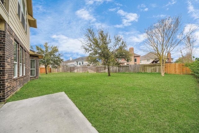 view of yard featuring a patio area and a fenced backyard