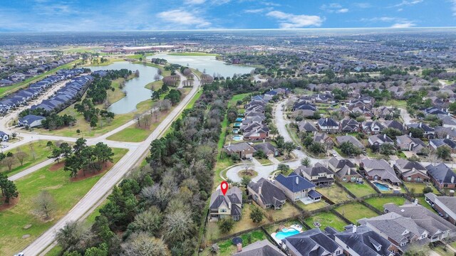 drone / aerial view with a water view and a residential view