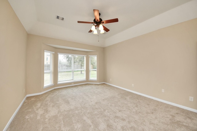 spare room featuring carpet floors, baseboards, and visible vents