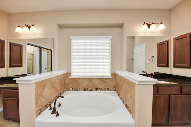 full bath featuring a garden tub and vanity