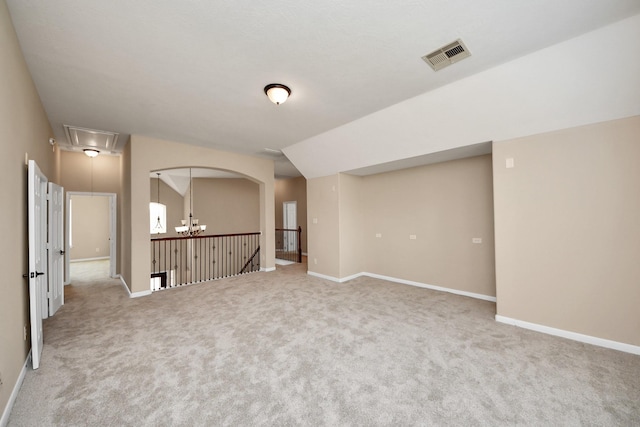 unfurnished room with carpet floors, attic access, visible vents, and baseboards