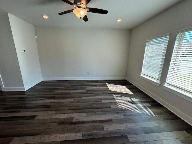 empty room featuring ceiling fan, baseboards, dark wood-style flooring, and recessed lighting