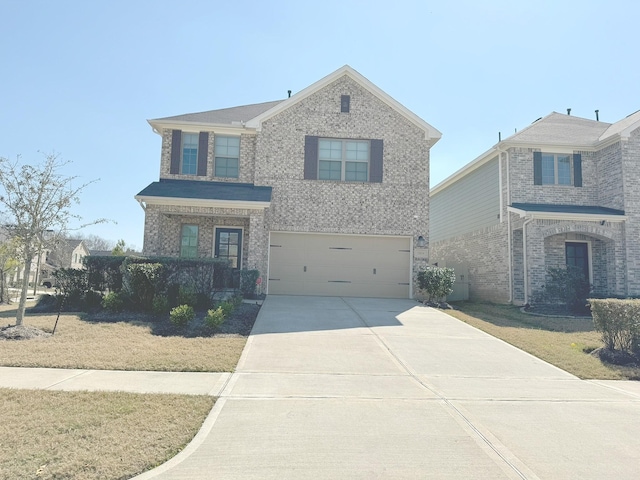 traditional-style home with brick siding, a garage, and concrete driveway