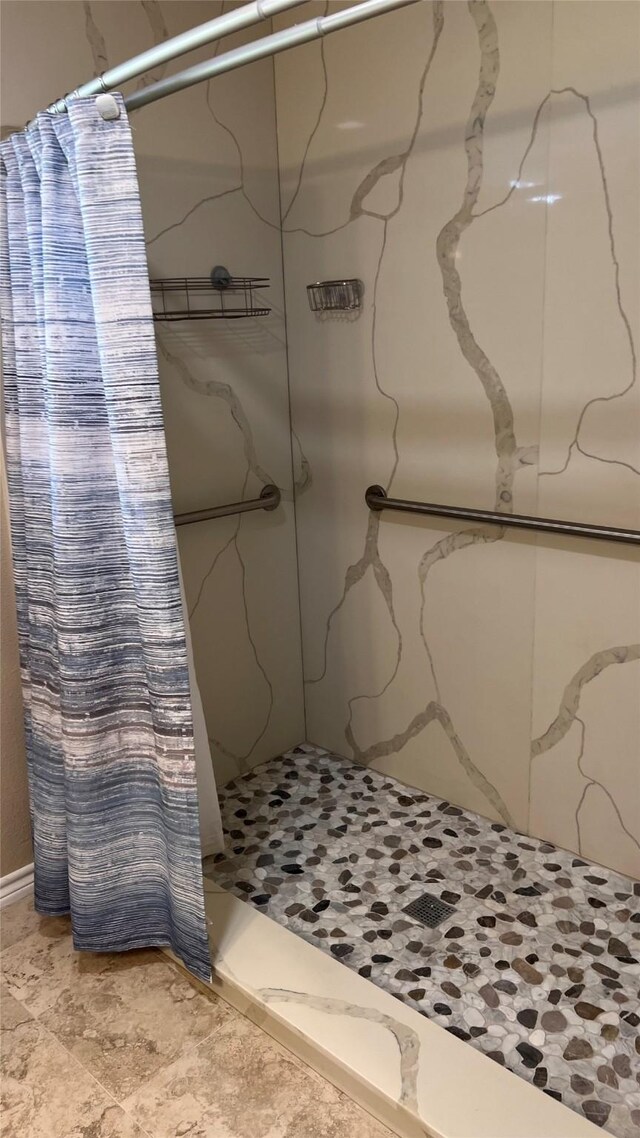 full bathroom with a marble finish shower