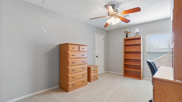 office space featuring light carpet, attic access, baseboards, and a textured ceiling