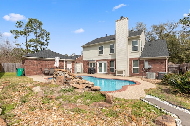 view of swimming pool featuring a patio area, a fenced in pool, fence, and central AC