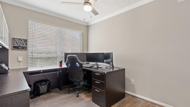 office area featuring ornamental molding, wood finished floors, a ceiling fan, and baseboards