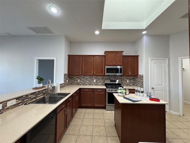 kitchen with light tile patterned floors, stainless steel appliances, a sink, and light countertops