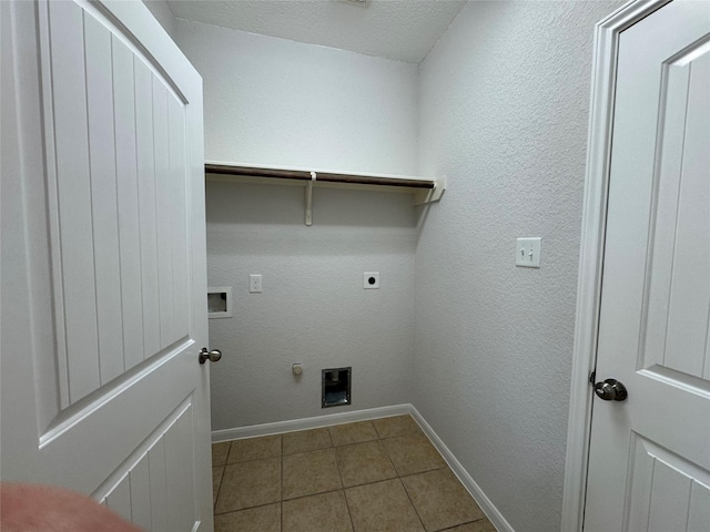 clothes washing area with gas dryer hookup, electric dryer hookup, laundry area, baseboards, and tile patterned floors