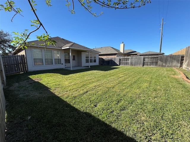 view of yard with a fenced backyard