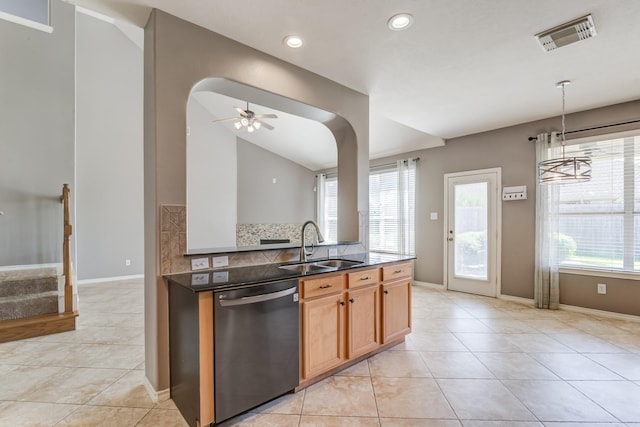 kitchen featuring visible vents, arched walkways, dishwashing machine, a sink, and light tile patterned flooring