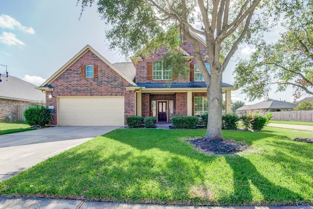 traditional-style house with driveway, fence, a front lawn, and brick siding