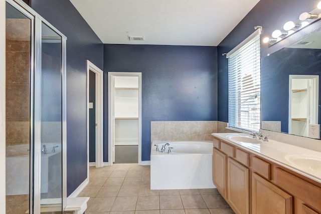 bathroom with a stall shower, visible vents, tile patterned floors, a garden tub, and a sink