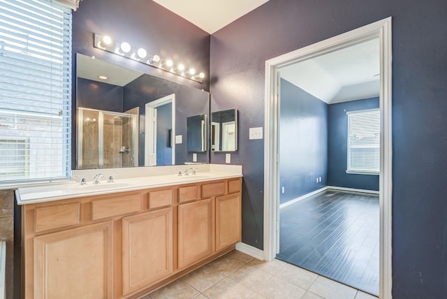 full bath featuring a stall shower, tile patterned flooring, a sink, and lofted ceiling