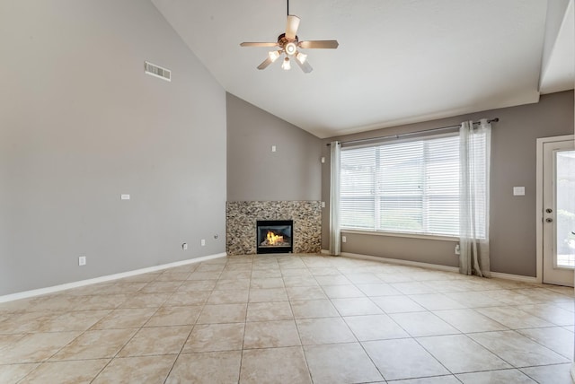 unfurnished living room with baseboards, visible vents, ceiling fan, a fireplace, and light tile patterned flooring