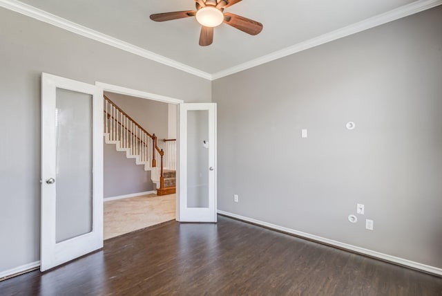 unfurnished room featuring baseboards, stairway, ornamental molding, wood finished floors, and french doors