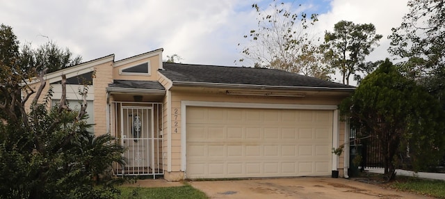 view of front of home with driveway and a garage