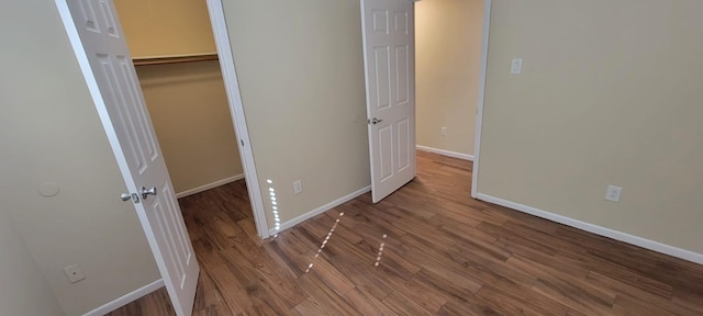 unfurnished bedroom with baseboards and wood finished floors