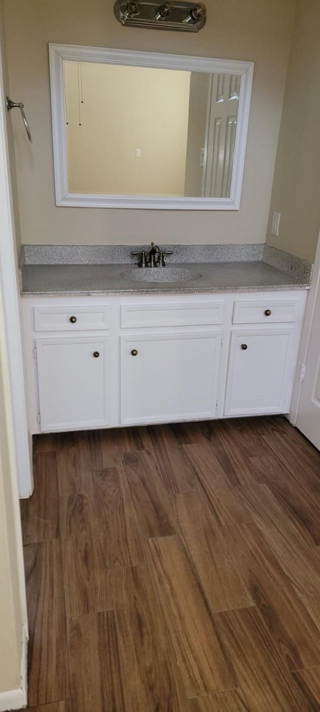 bathroom featuring wood finished floors and vanity