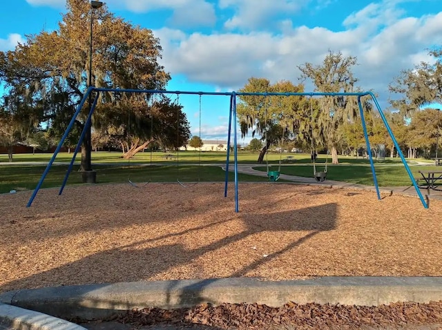 community jungle gym with a yard