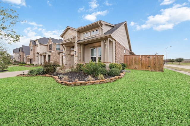 view of front of house with brick siding and a front yard