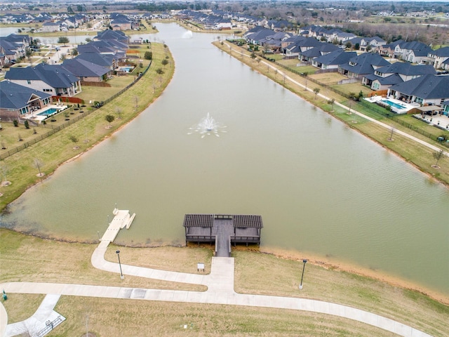 drone / aerial view featuring a water view and a residential view