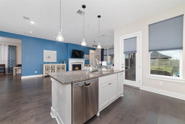 kitchen with open floor plan, stainless steel dishwasher, a sink, and visible vents