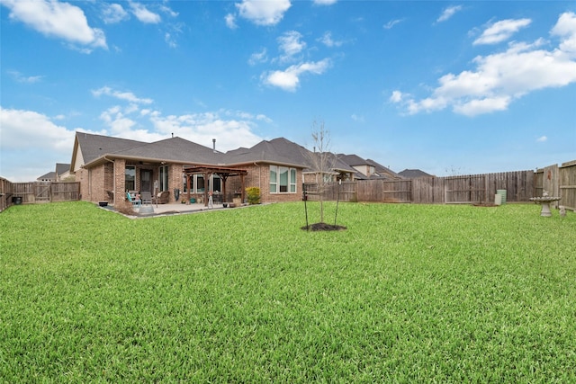 view of yard with a patio area and a fenced backyard