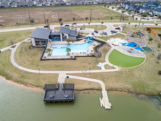 drone / aerial view featuring a water view and a residential view