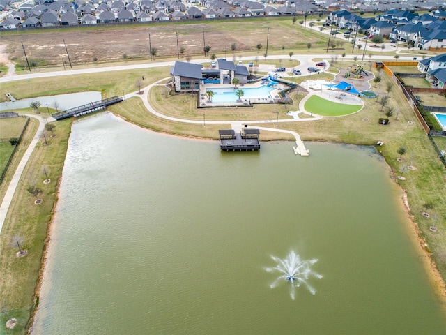 birds eye view of property with a water view and a residential view