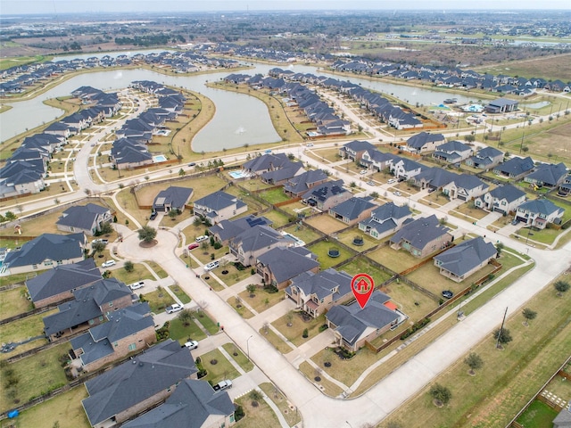 drone / aerial view with a residential view and a water view