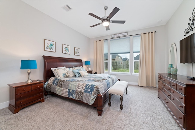 bedroom featuring visible vents, ceiling fan, light carpet, and baseboards