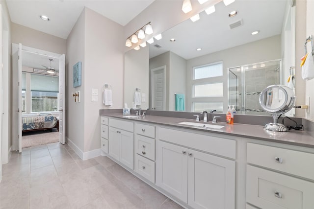 ensuite bathroom with a stall shower, visible vents, a sink, and ensuite bathroom