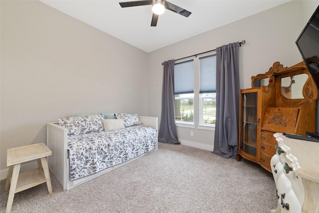 carpeted bedroom featuring ceiling fan and baseboards